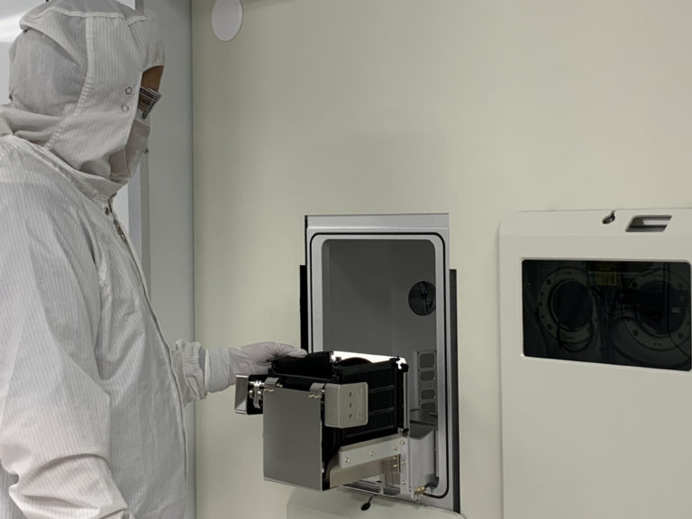 Cleanroom technician working with wafer fabrication equipment